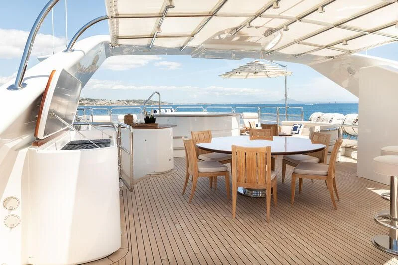 a boat with a table and chairs aboard CHECKMATE Yacht for Charter