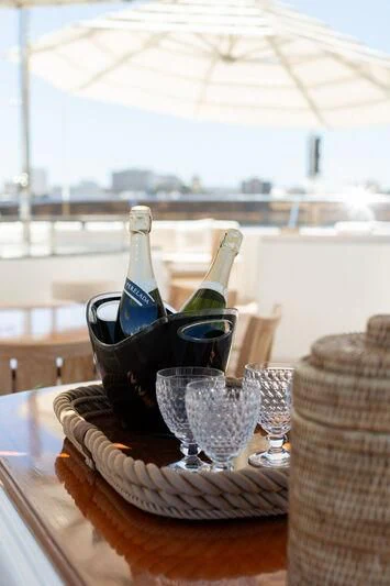 a table with glasses and bottles aboard CHECKMATE Yacht for Charter