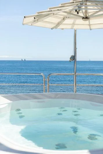 a white umbrella over a pool of water aboard CHECKMATE Yacht for Charter
