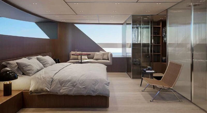 a room with a bed and a chair aboard SANLORENZO SX100/119 Yacht for Sale