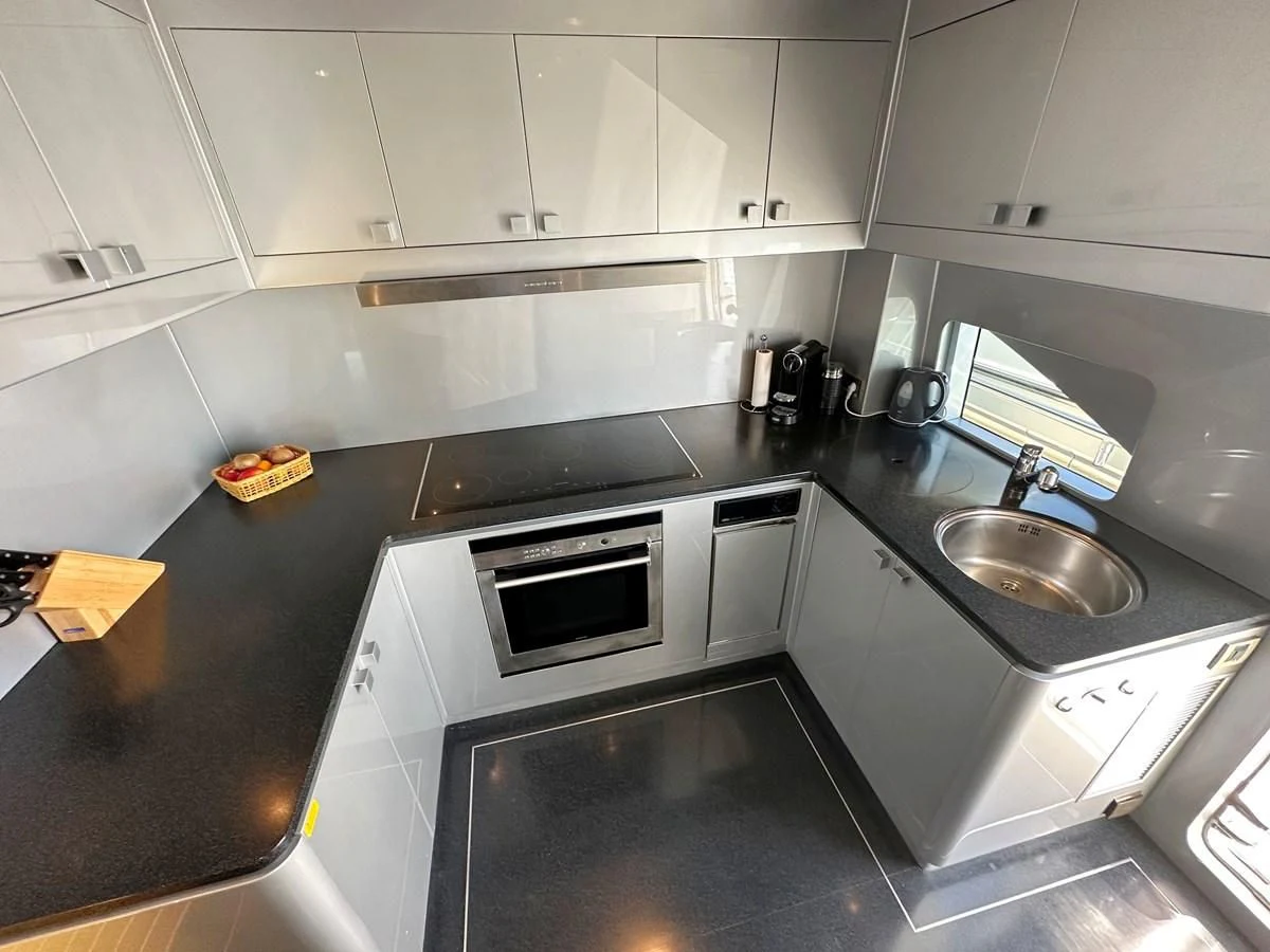 a kitchen with white cabinets aboard ESPRESSO Yacht for Sale