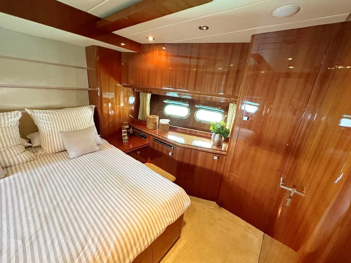 a room with a bed and a wood wall aboard ESPRESSO Yacht for Sale