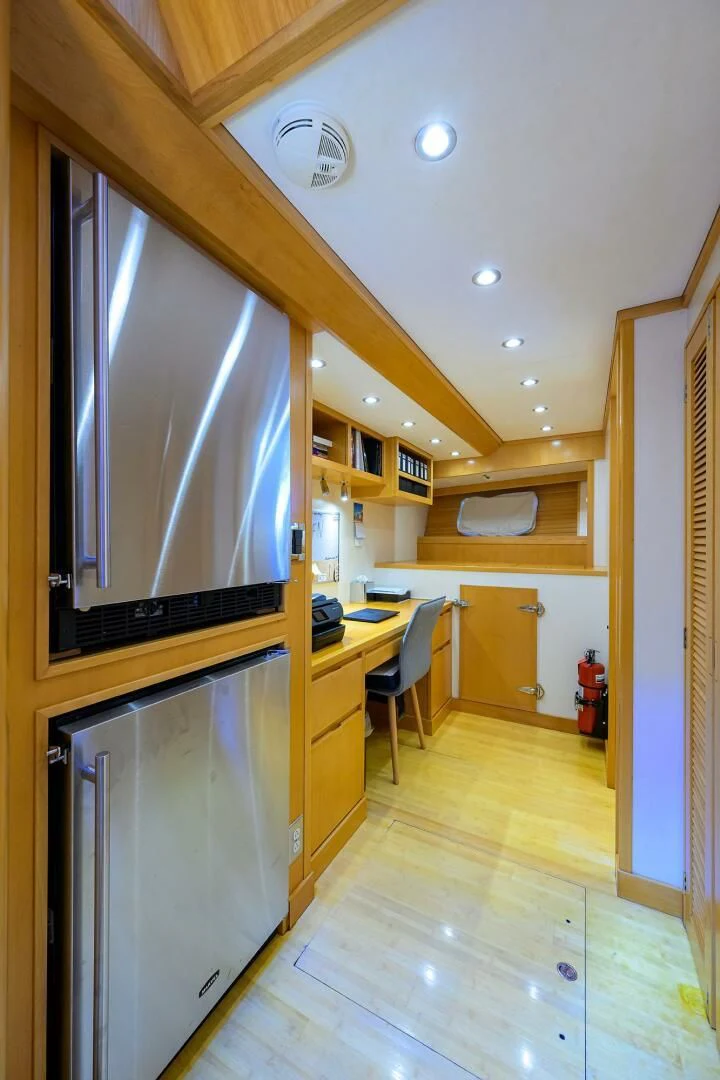 a kitchen with a refrigerator and microwave aboard ELECTRA Yacht for Sale