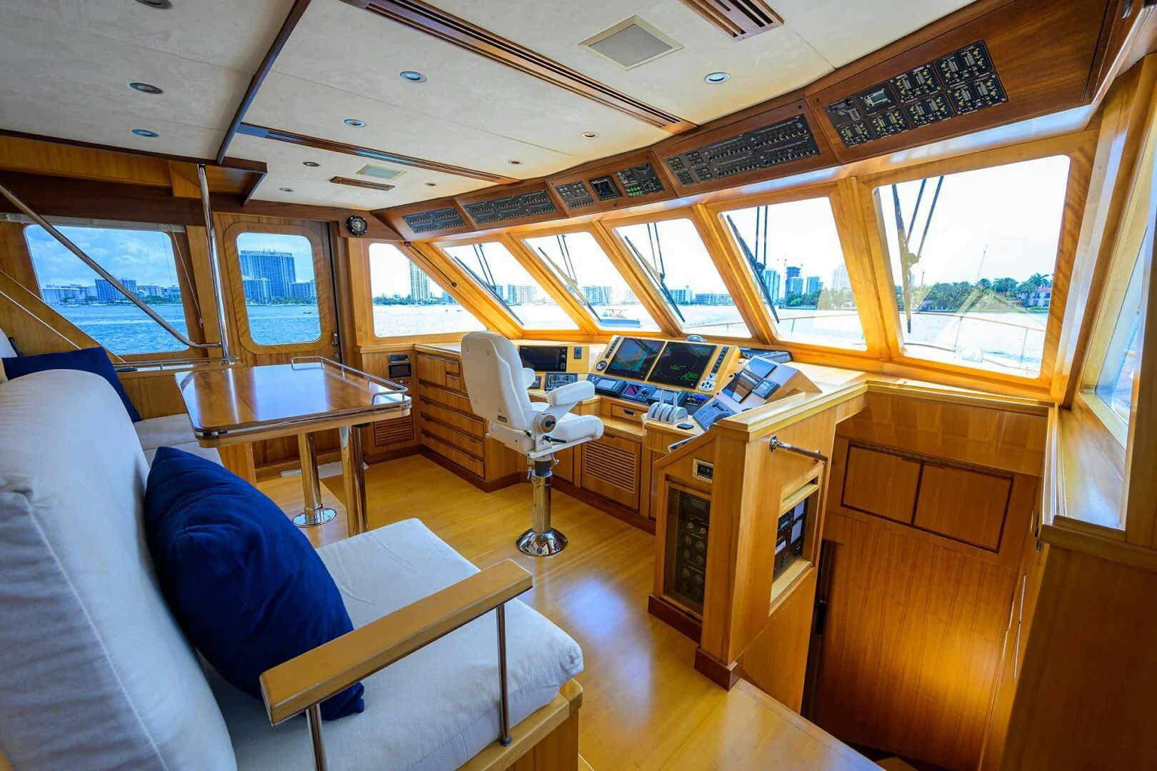 a room with a couch and a table with chairs aboard ELECTRA Yacht for Sale