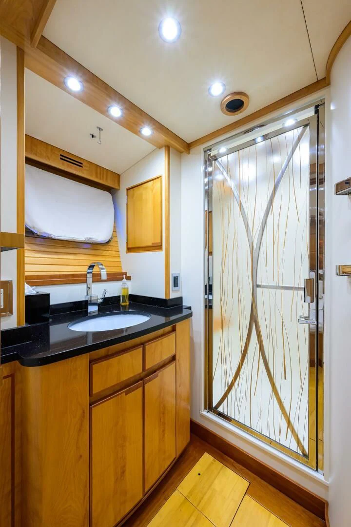 a bathroom with a glass shower door aboard ELECTRA Yacht for Sale