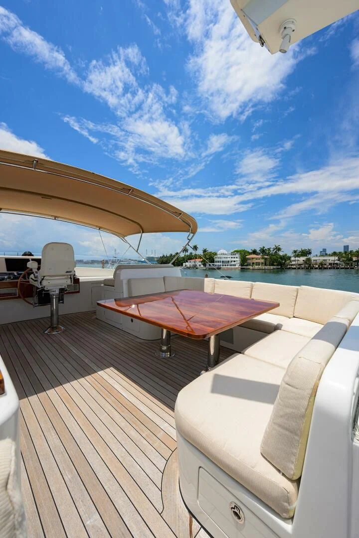 a deck with a table and chairs on it aboard ELECTRA Yacht for Sale