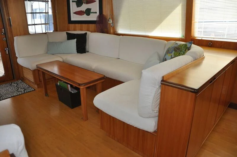 a living room with a couch and coffee table aboard ELECTRA Yacht for Sale