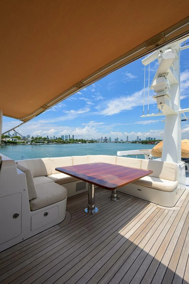 a pool table and chairs on a deck overlooking a body of water aboard ELECTRA Yacht for Sale
