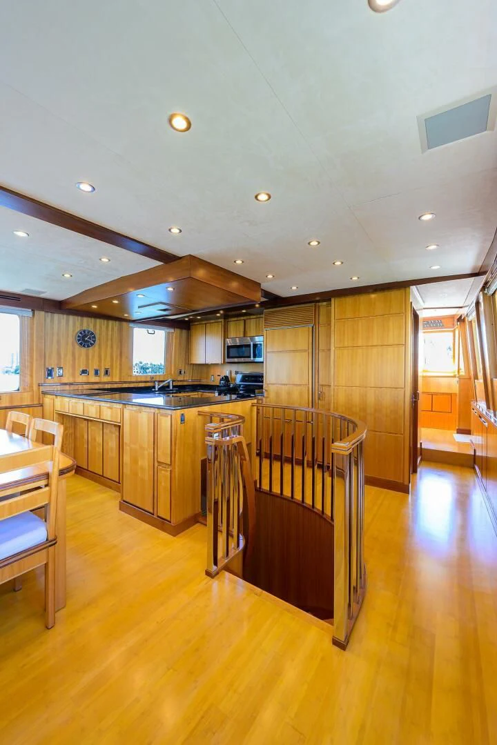 a kitchen with wooden cabinets aboard ELECTRA Yacht for Sale