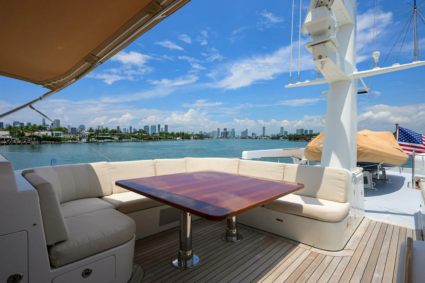 a pool table and chairs on a deck overlooking a beach aboard ELECTRA Yacht for Sale