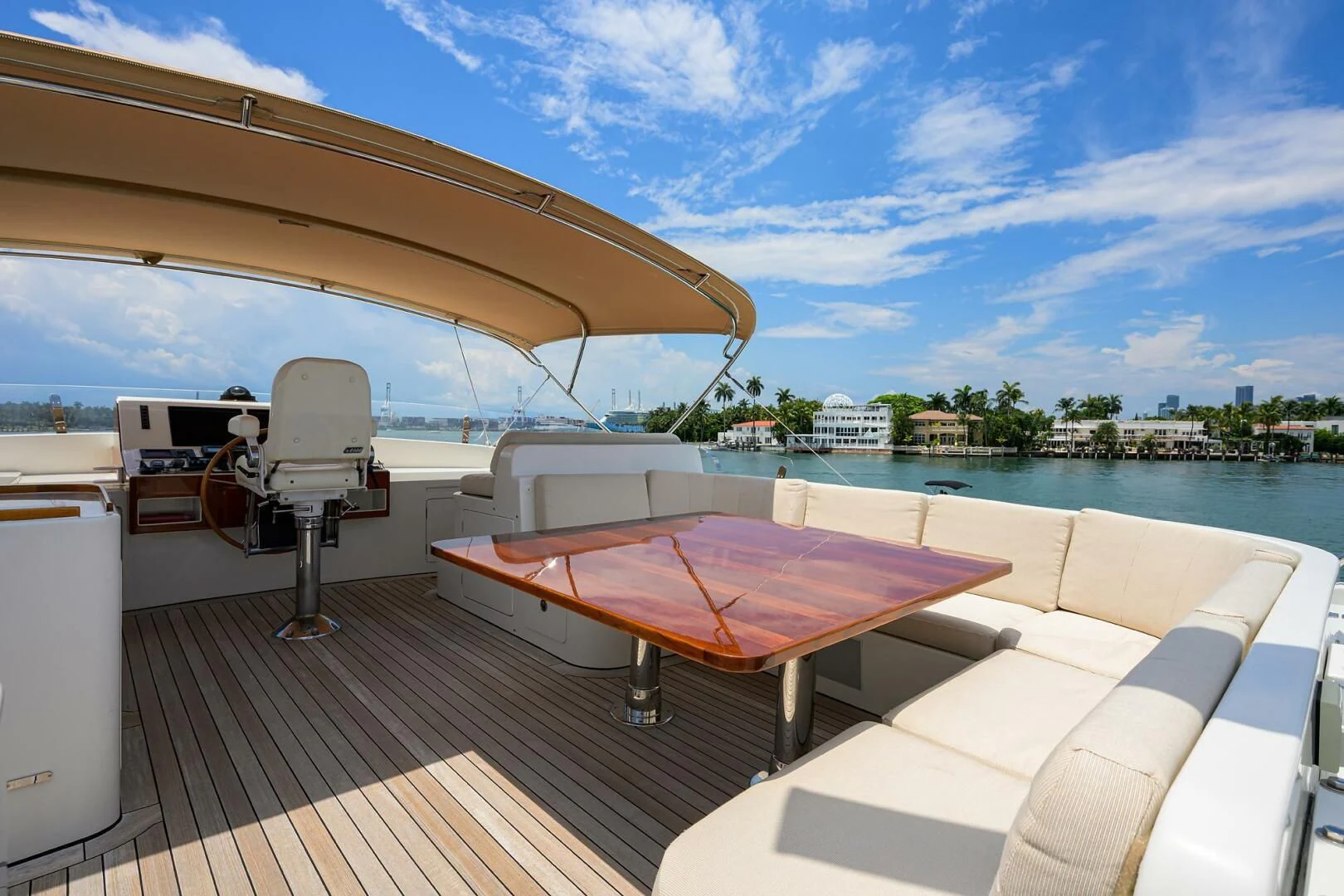 a deck with a table and chairs on it by a pool aboard ELECTRA Yacht for Sale