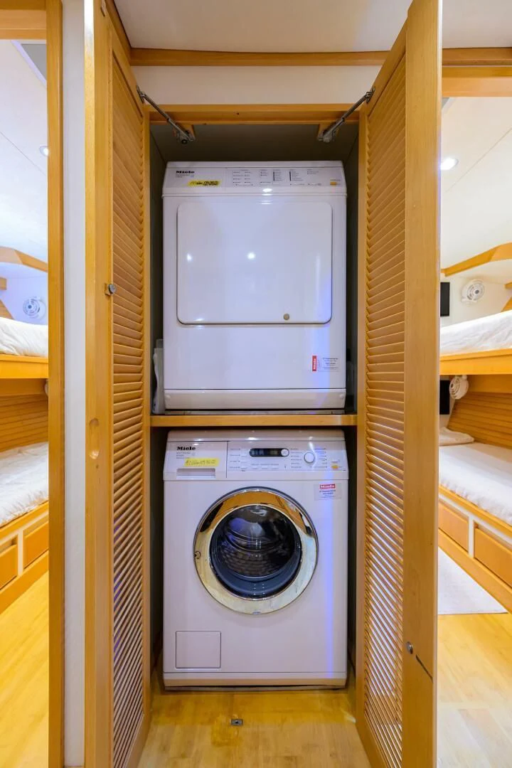 a washing machine in a room aboard ELECTRA Yacht for Sale
