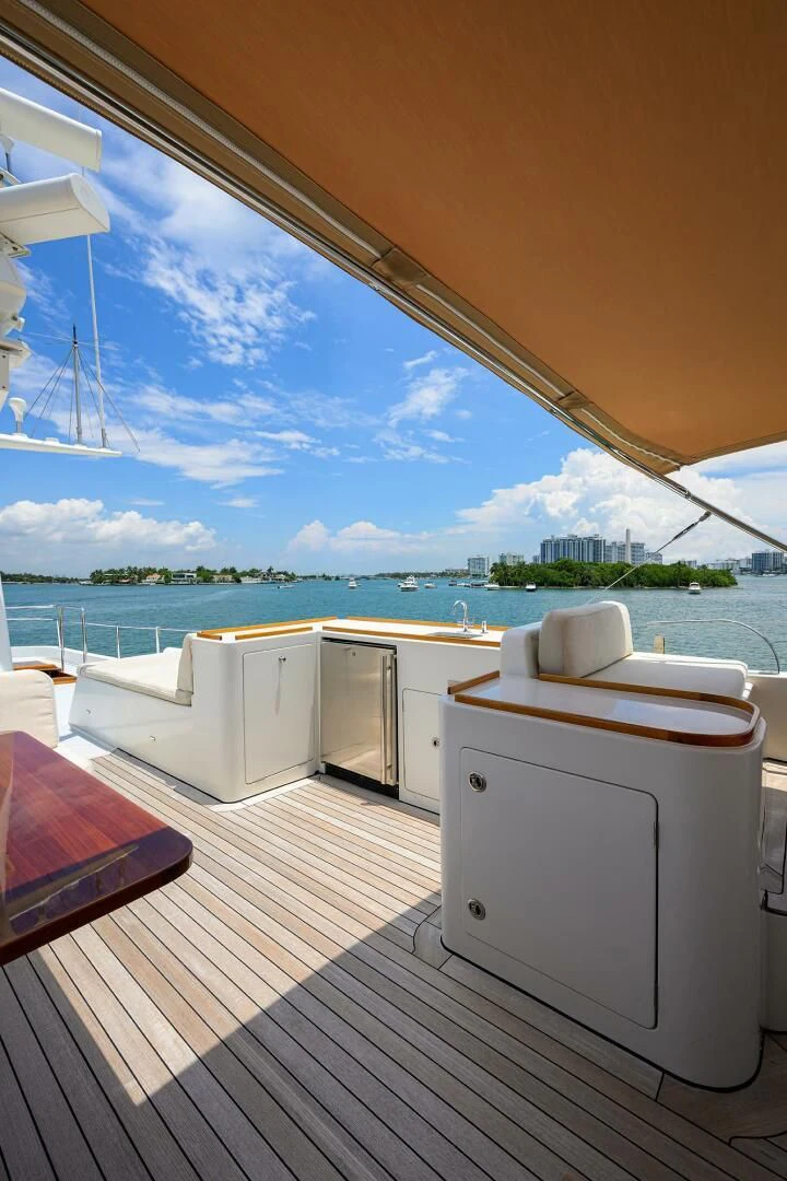 a deck with a view of the ocean and a beach aboard ELECTRA Yacht for Sale