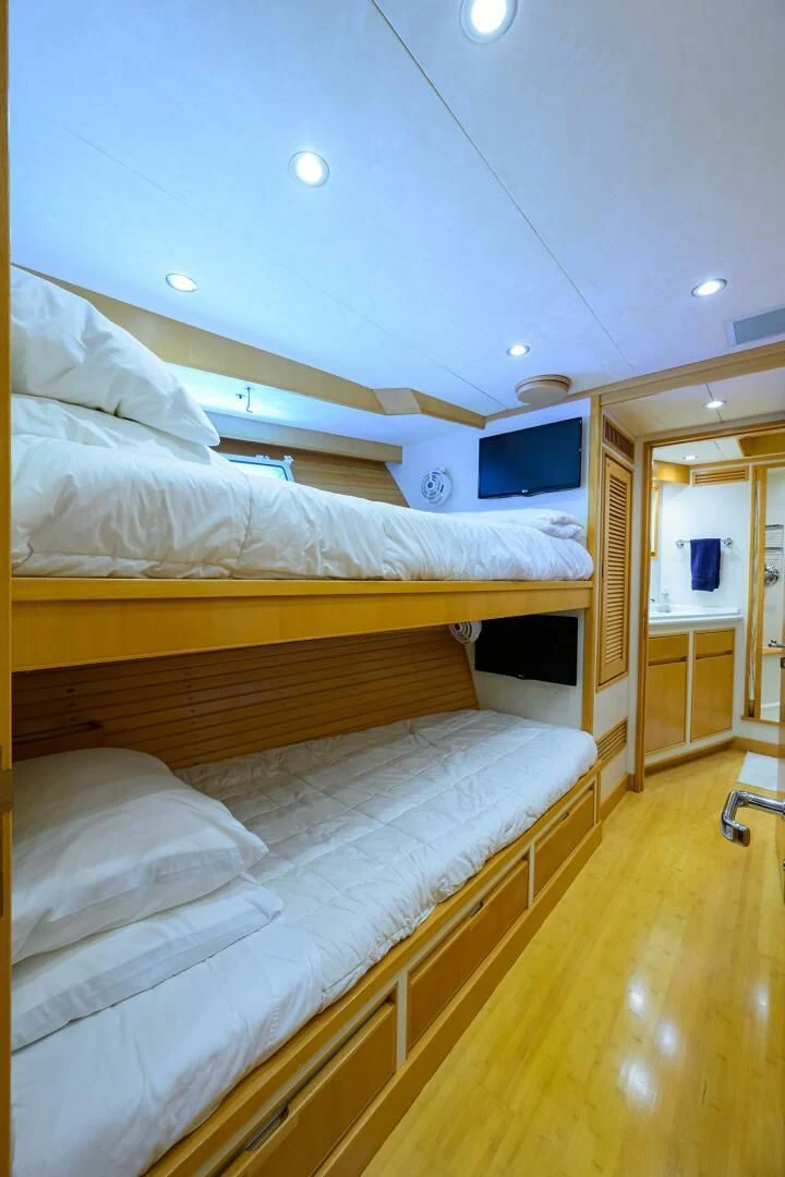 a room with a bed and a television aboard ELECTRA Yacht for Sale