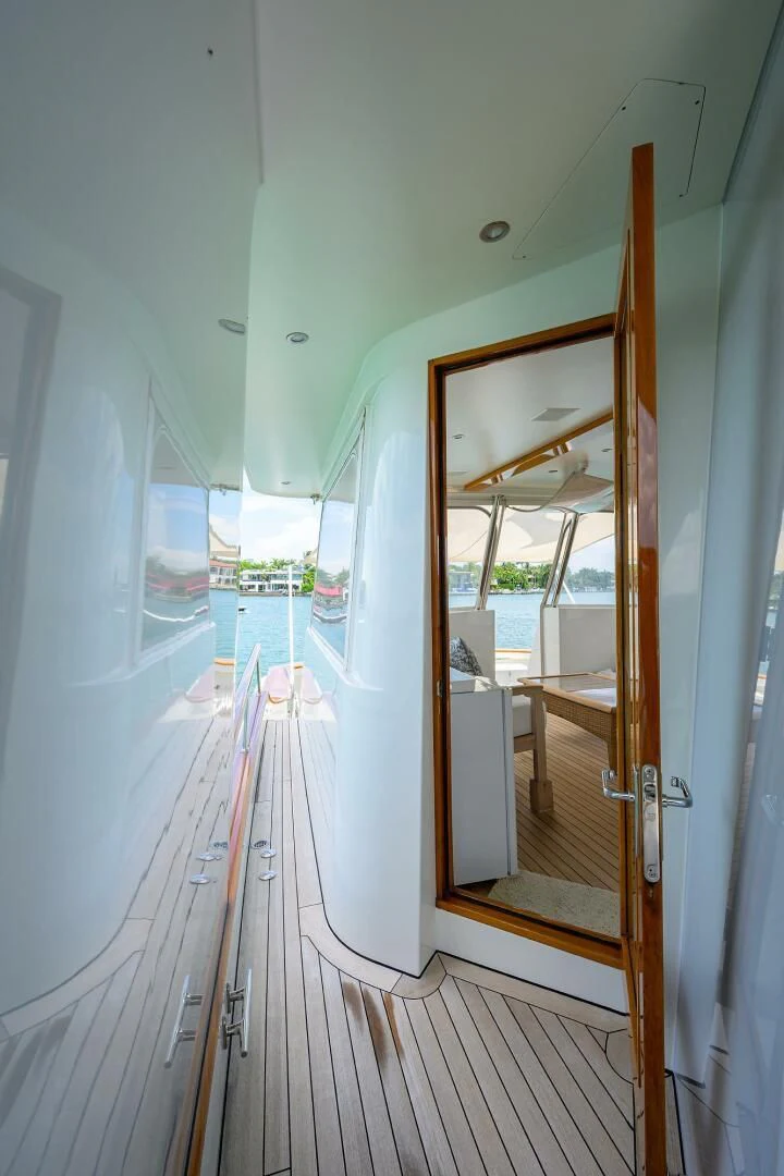 a wooden porch with a glass door aboard ELECTRA Yacht for Sale