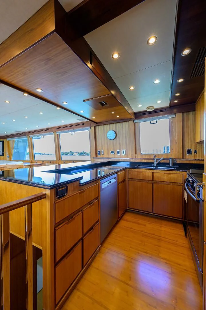 a kitchen with wooden cabinets aboard ELECTRA Yacht for Sale