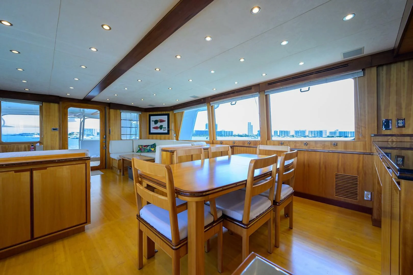 a large room with tables and chairs aboard ELECTRA Yacht for Sale