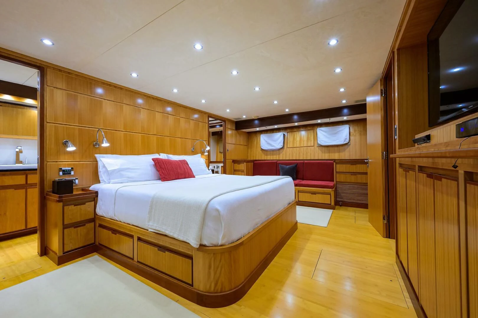 a bedroom with a bed and a wood floor aboard ELECTRA Yacht for Sale