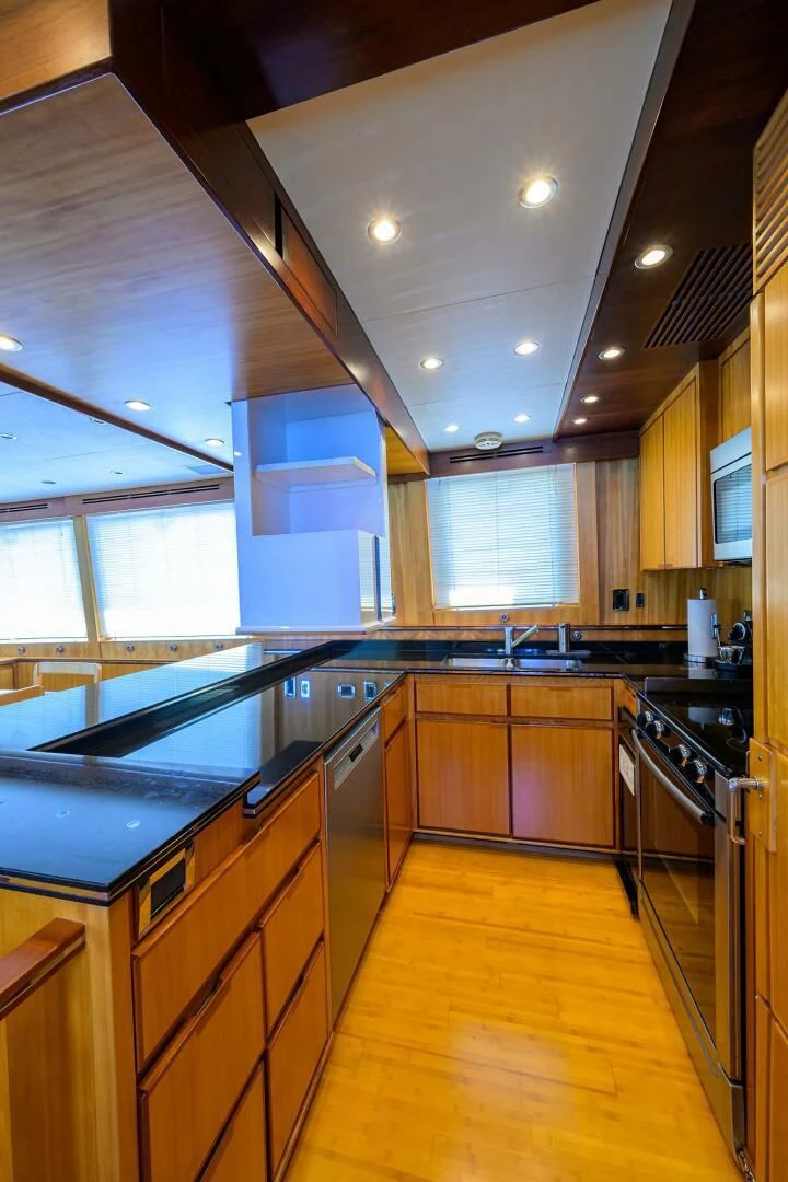 a kitchen with wooden cabinets aboard ELECTRA Yacht for Sale