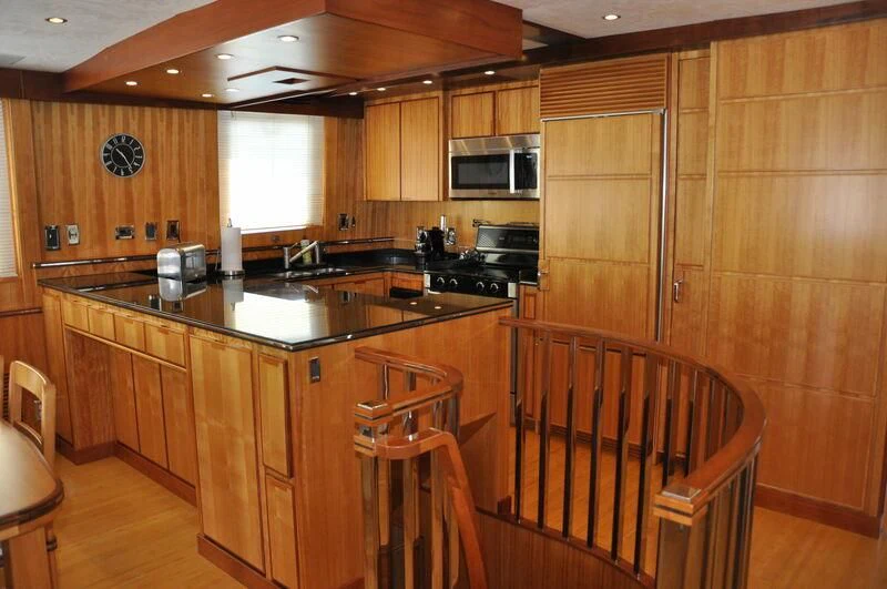 a kitchen with wooden cabinets aboard ELECTRA Yacht for Sale
