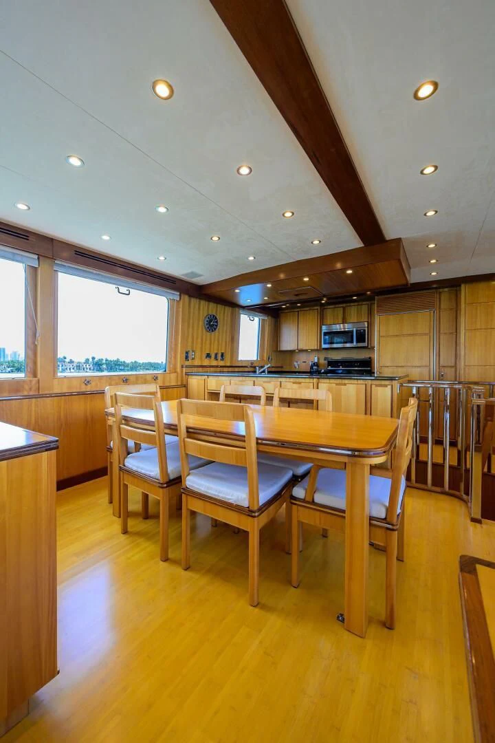 a kitchen with a table and chairs aboard ELECTRA Yacht for Sale