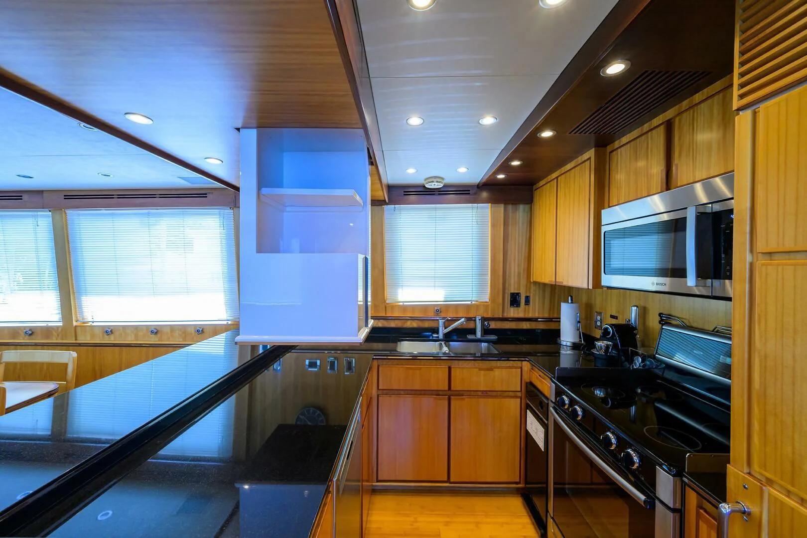 a kitchen with wooden cabinets aboard ELECTRA Yacht for Sale