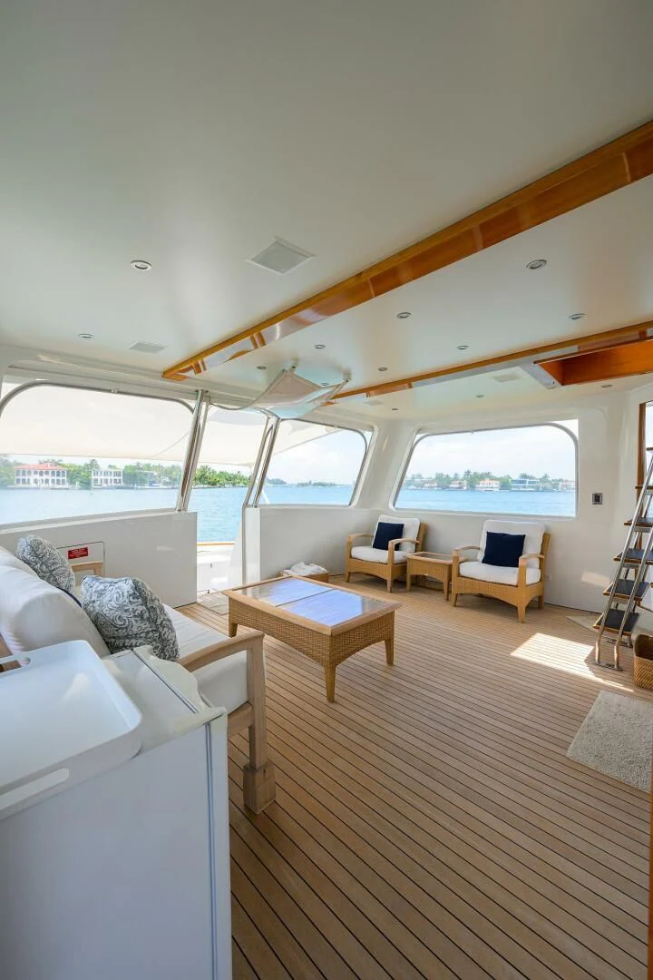 a room with a large window and a wood floor aboard ELECTRA Yacht for Sale