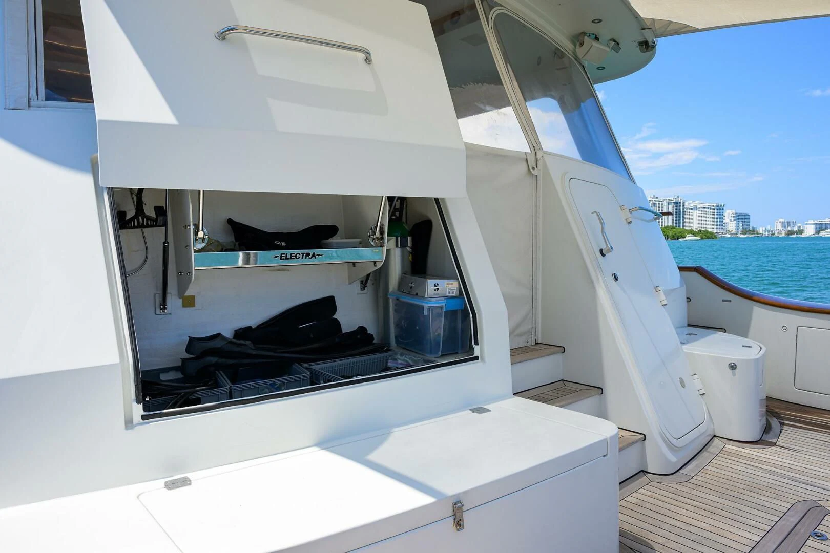a white boat with a black seat aboard ELECTRA Yacht for Sale