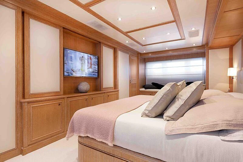 a bedroom with a bed and a television aboard THEOLINA Yacht for Sale