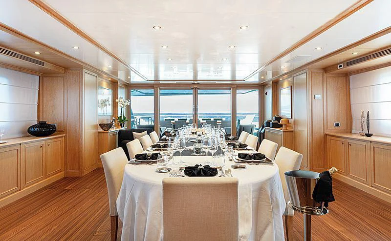 a large dining room with a large table and chairs aboard THEOLINA Yacht for Sale