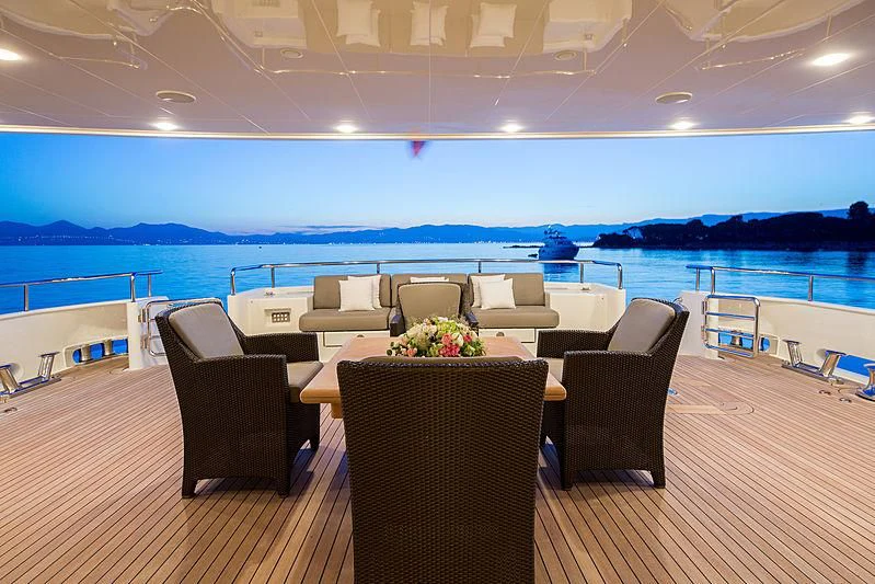a room with chairs and a table aboard THEOLINA Yacht for Sale