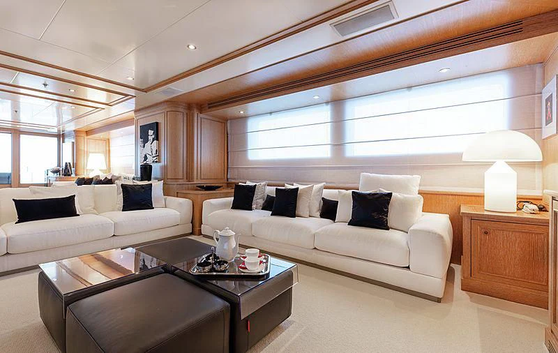 a living room with a white couch and a coffee table aboard THEOLINA Yacht for Sale