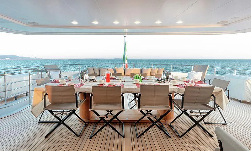 a table with chairs around it aboard THEOLINA Yacht for Sale