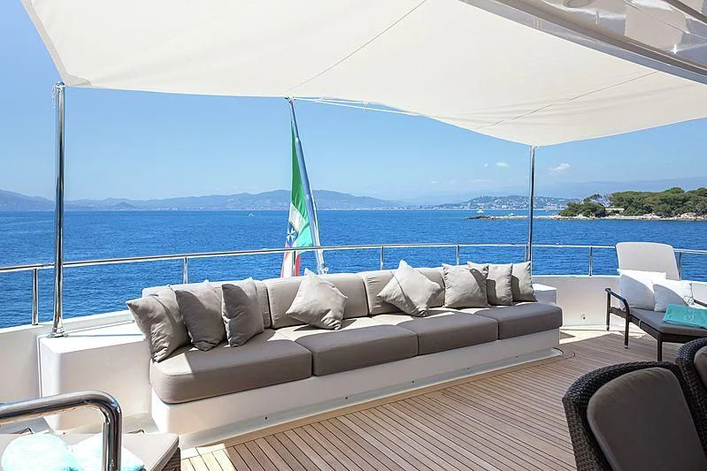 a couch on a deck overlooking the ocean aboard THEOLINA Yacht for Sale