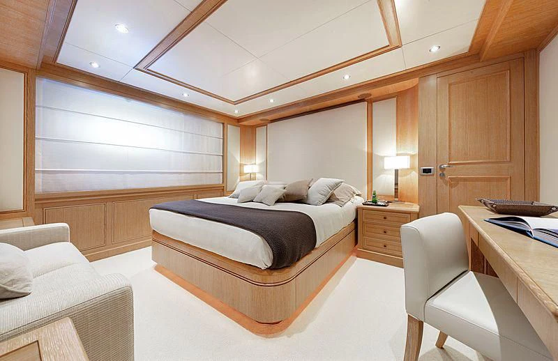 a room with a bed and a desk aboard THEOLINA Yacht for Sale