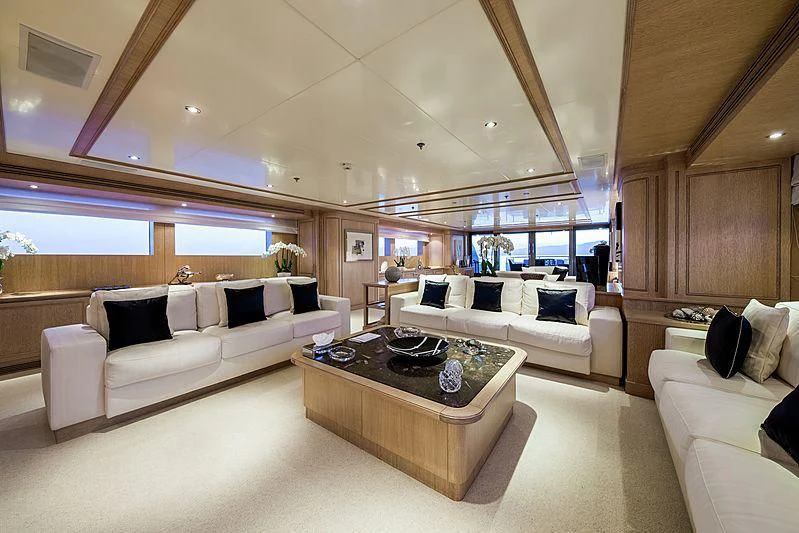 a living room with a couch and a coffee table aboard THEOLINA Yacht for Sale