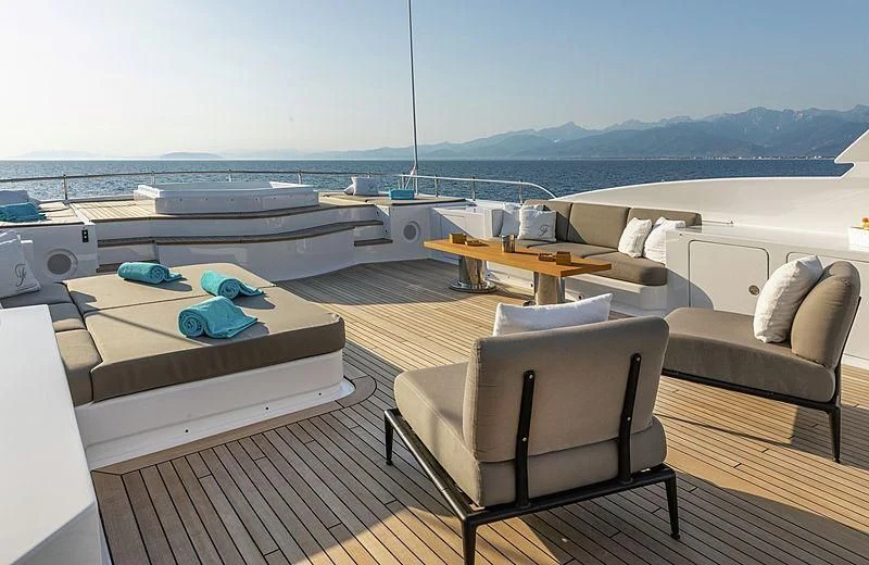 a deck with a deck and chairs aboard THEOLINA Yacht for Sale