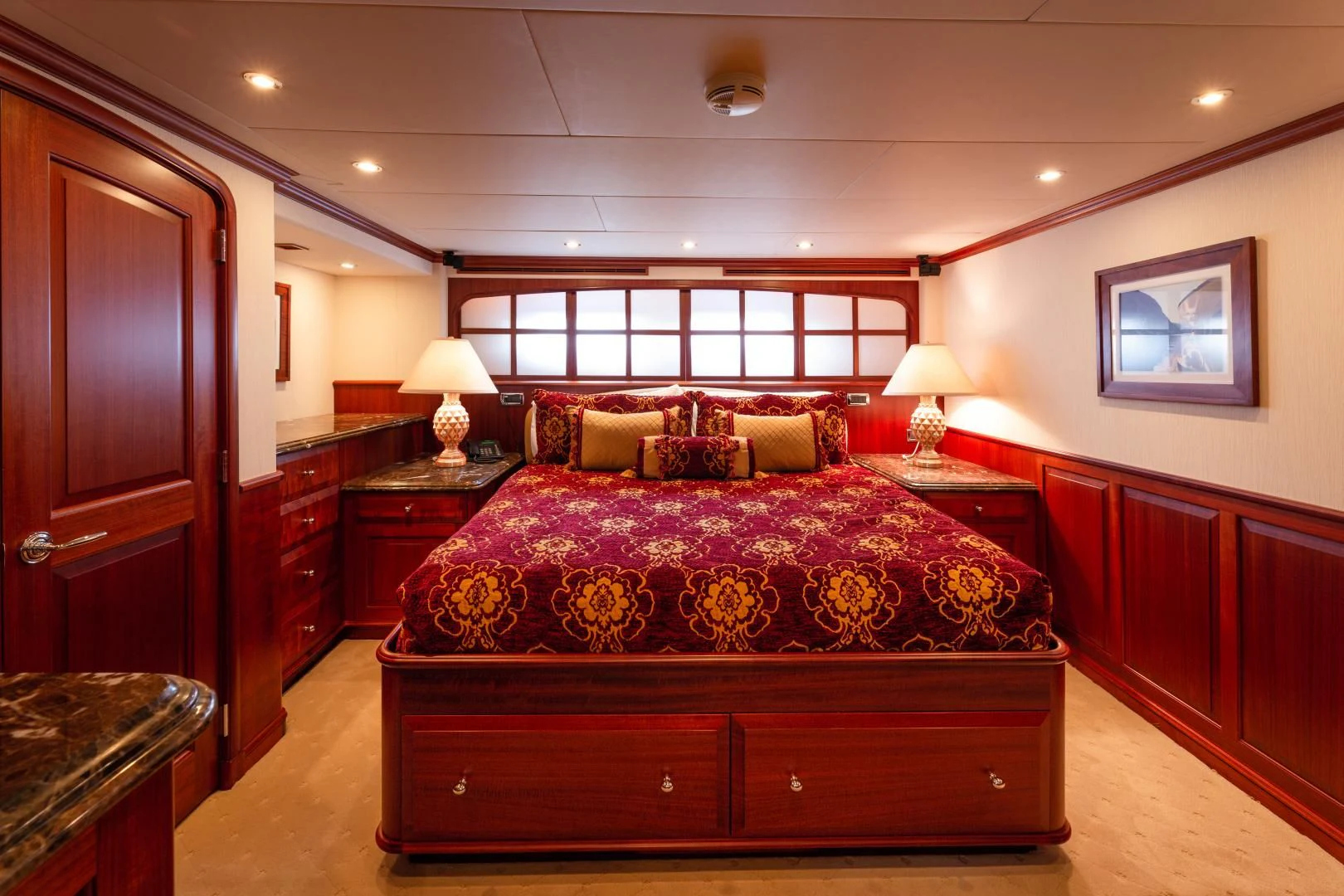 a bedroom with a bed and a dresser aboard ISLANDER Yacht for Sale