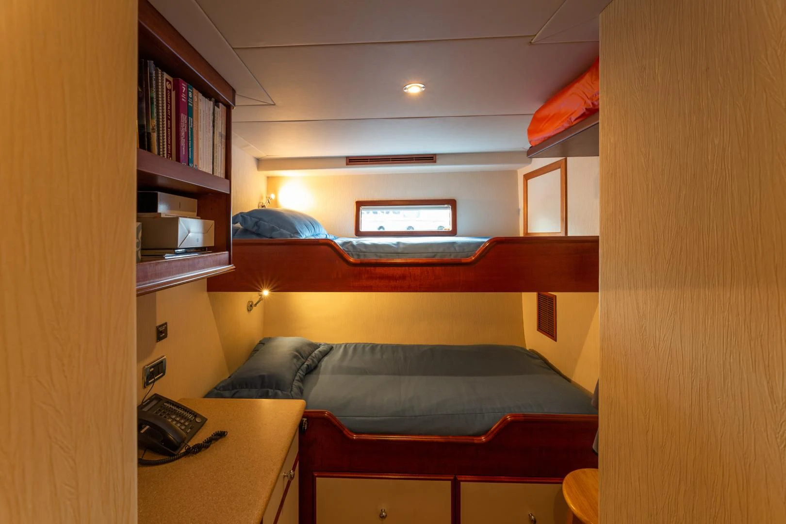 a bedroom with a desk and a bed aboard ISLANDER Yacht for Sale
