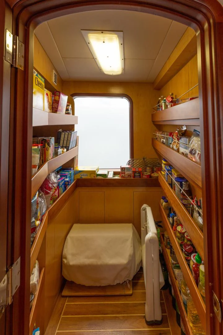 a room with shelves and shelves aboard ISLANDER Yacht for Sale