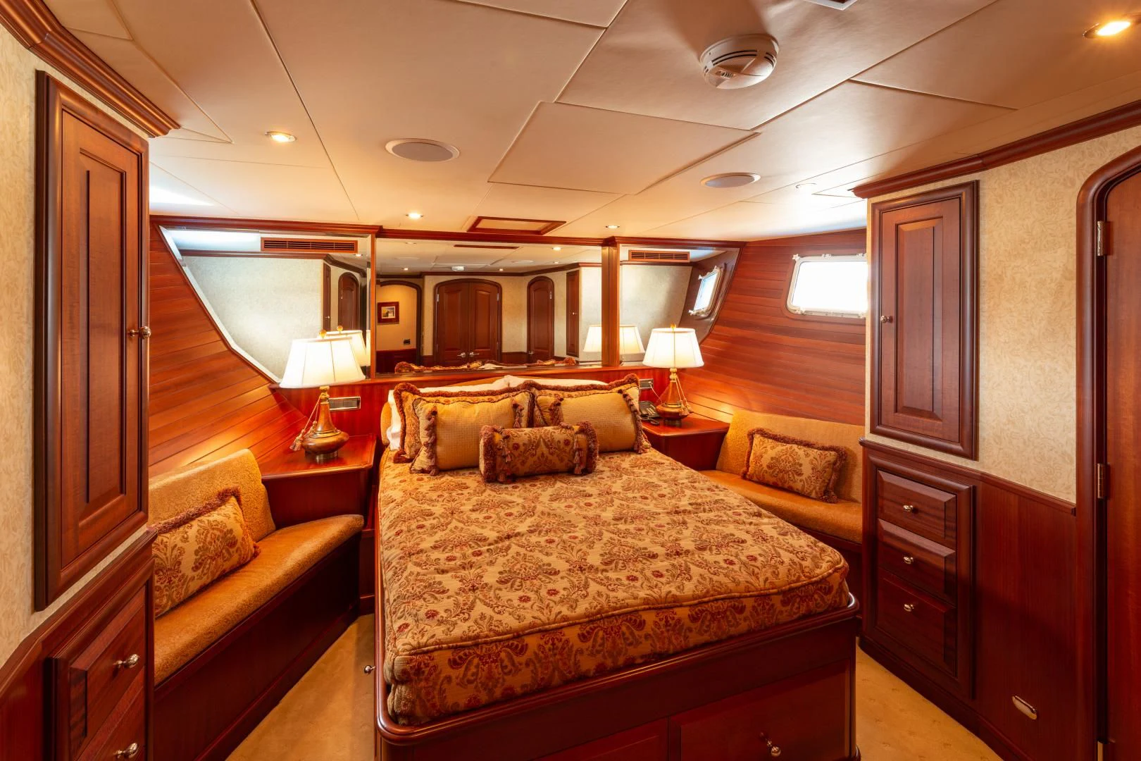 a bedroom with a bed and a couch aboard ISLANDER Yacht for Sale