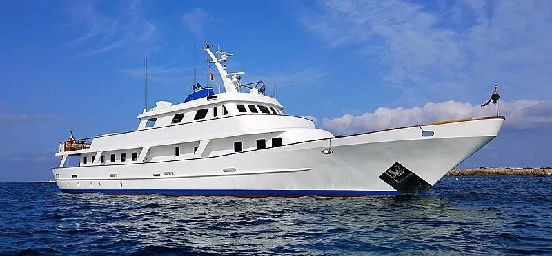 a boat with a white tail and a blue sky above aboard TRAFALGAR Yacht for Sale