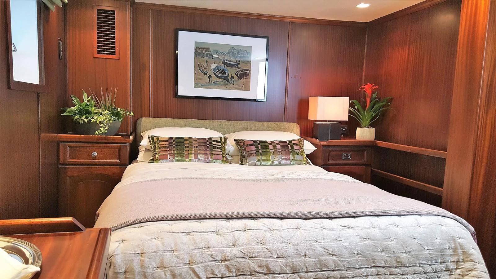 a bed with a lamp on it aboard TRAFALGAR Yacht for Sale