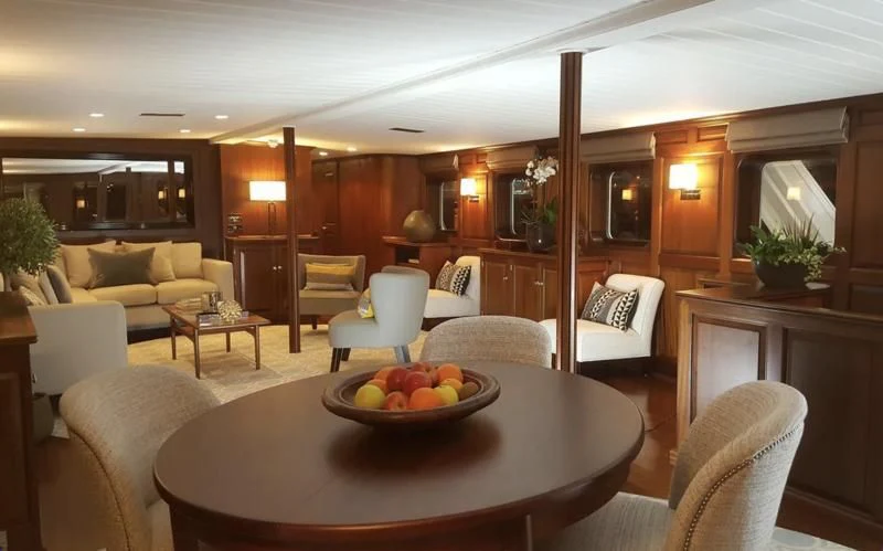 a room with a table and chairs aboard TRAFALGAR Yacht for Sale