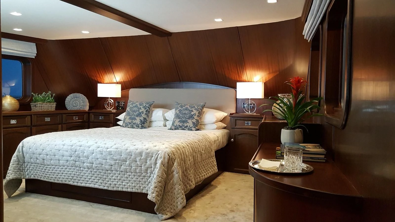 a bed with a white comforter and pillows in a hotel room aboard TRAFALGAR Yacht for Sale