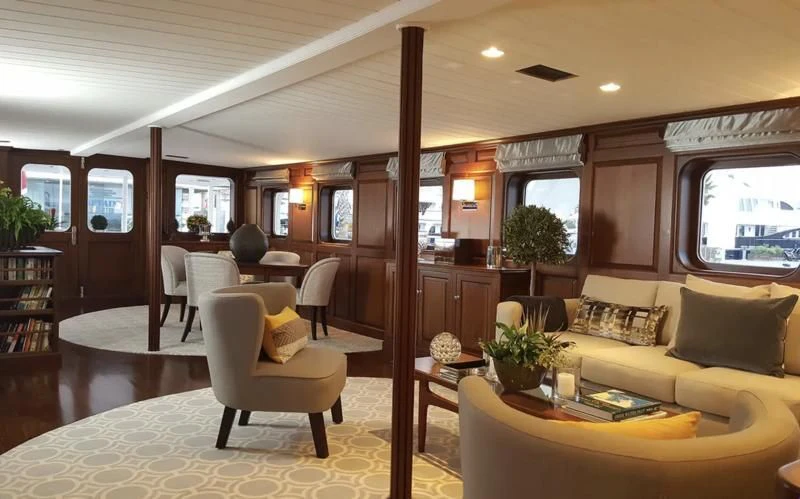 a living room with a couch and a table aboard TRAFALGAR Yacht for Sale