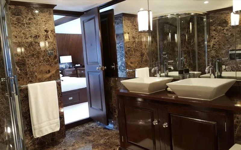 a bathroom with a sink and a mirror aboard TRAFALGAR Yacht for Sale