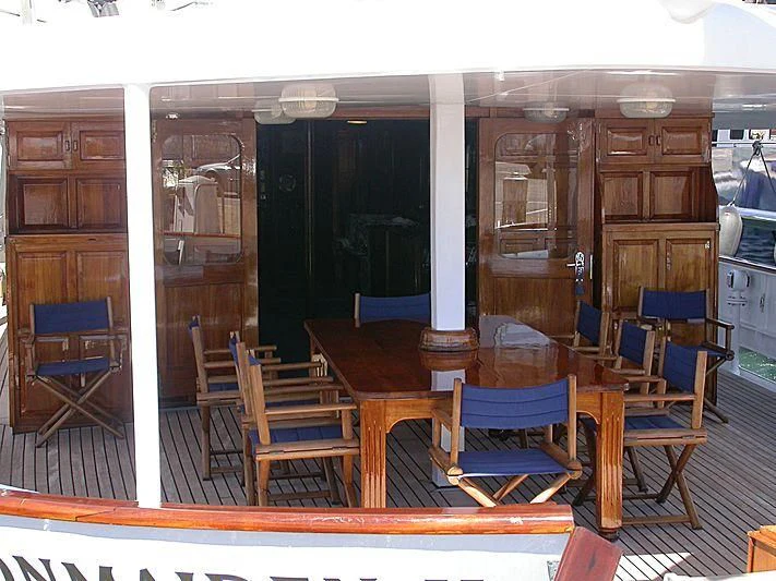 a dining room with chairs and a table aboard TRAFALGAR Yacht for Sale
