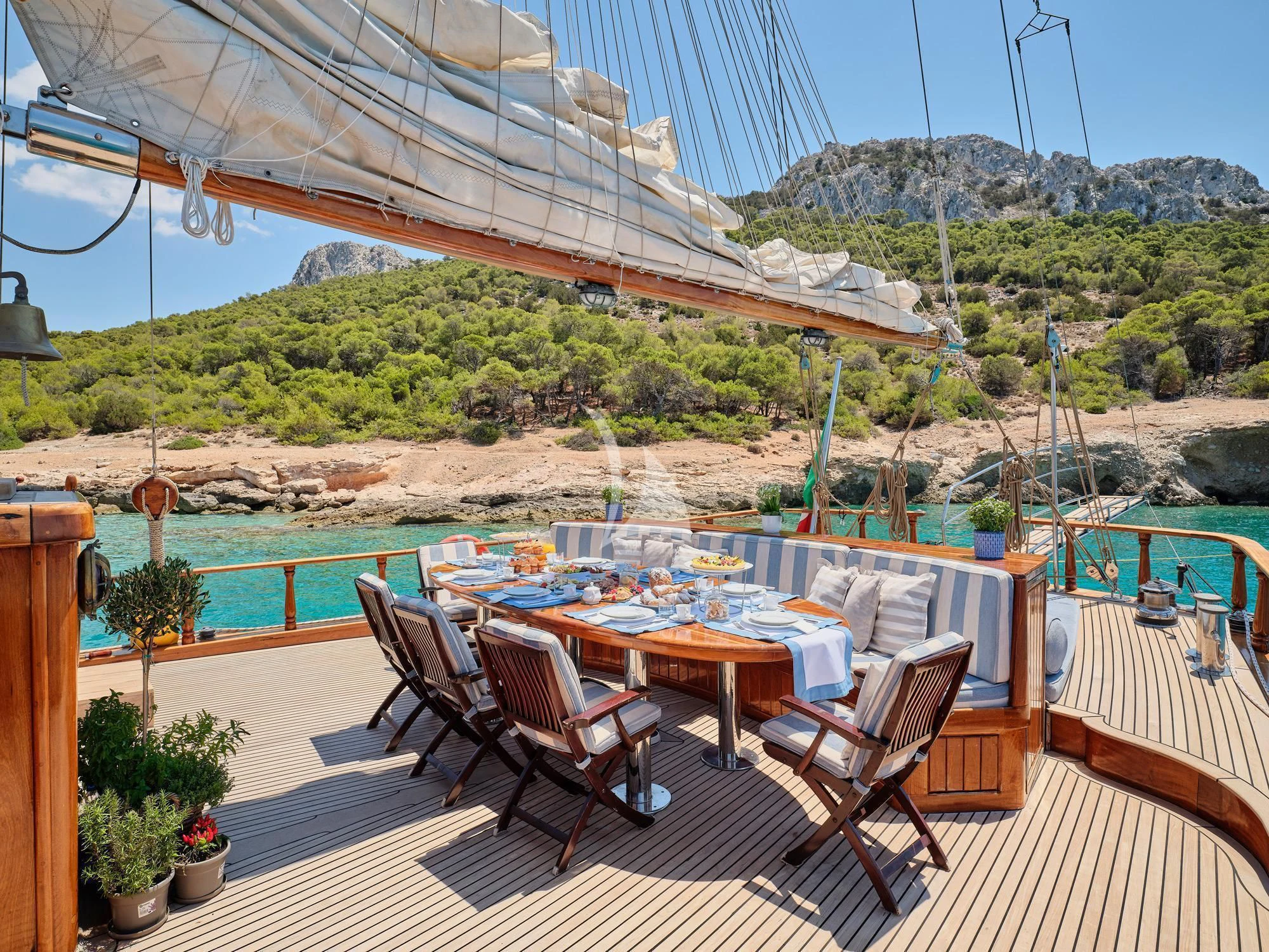 a patio with a table and chairs on it aboard MYRA Yacht for Sale