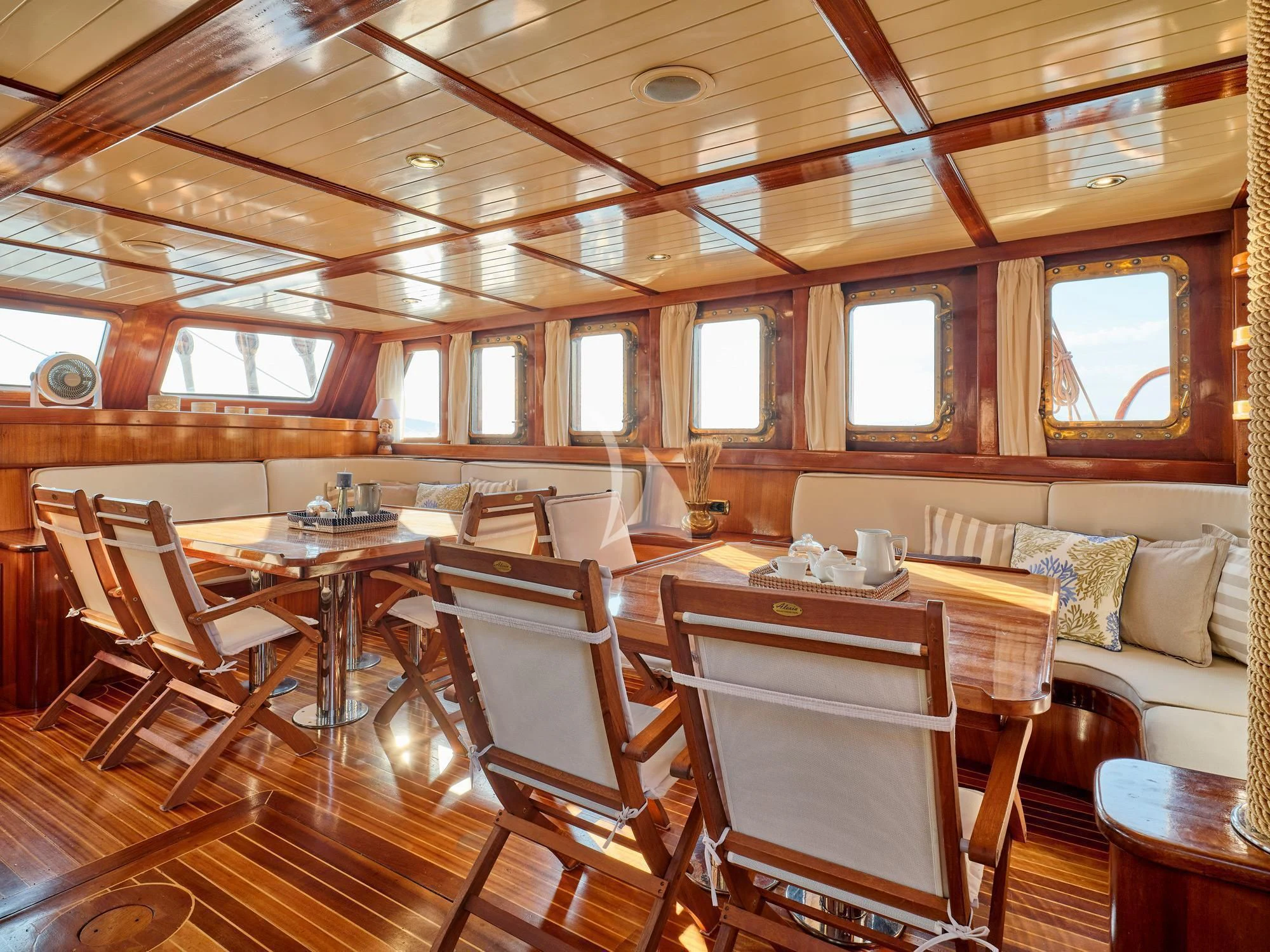 a room with a table and chairs aboard MYRA Yacht for Sale